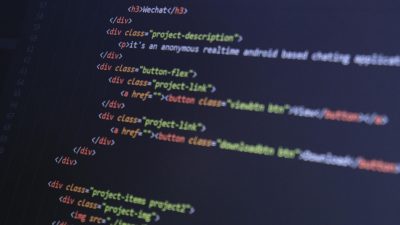 Close-up of HTML code with syntax highlighting on a computer monitor.