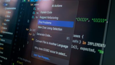 Detailed view of a computer screen displaying code with a menu of AI actions, illustrating modern software development.