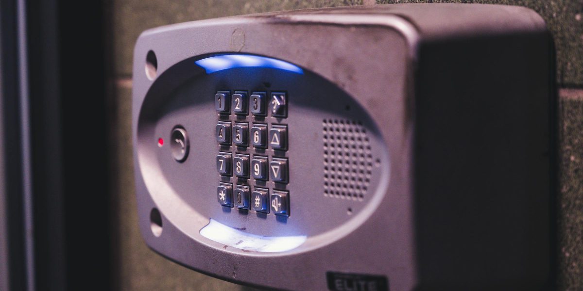 Illuminated security keypad mounted on a wall.