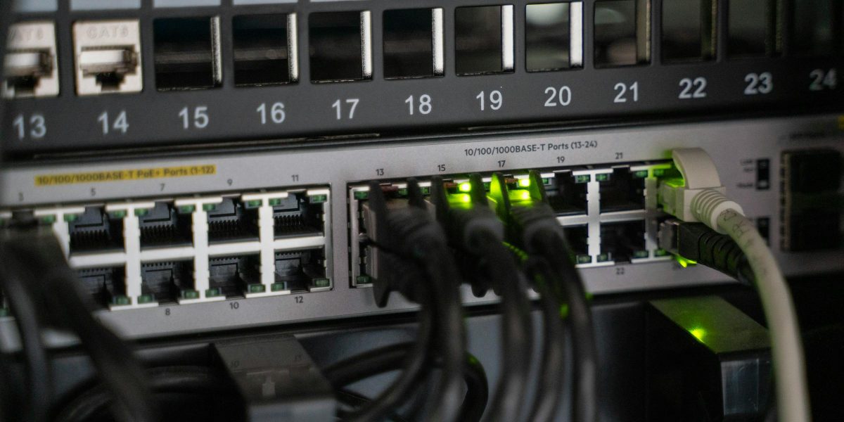 Networking equipment with connected cables, showcasing modern technology infrastructure.