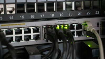 Networking equipment with connected cables, showcasing modern technology infrastructure.