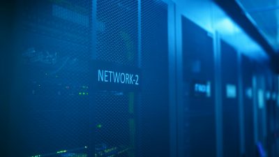 A modern server room featuring network equipment with blue illumination. Ideal for technology themes.