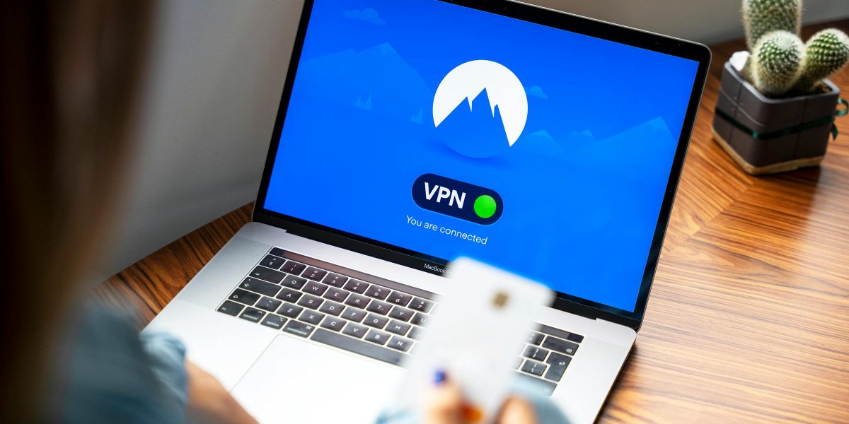 A person using a VPN on a laptop, symbolizing secure internet browsing in a modern indoor setting.