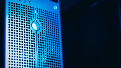 Close-up of a blue-lit server rack in a secure data center.